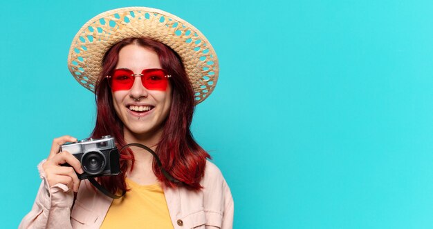 Pretty traveller woman with camera