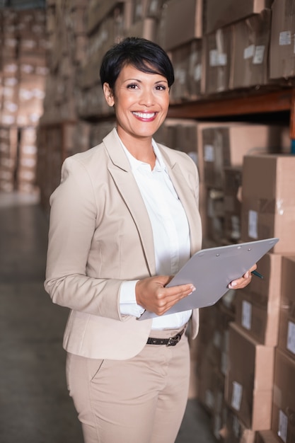 Pretty warehouse manager smiling at camera