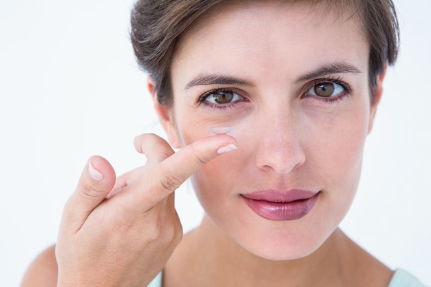 Pretty woman applying contact lens