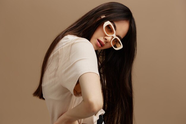 pretty woman attractive look charmin dark glasses in a tshirt beige background high quality photo