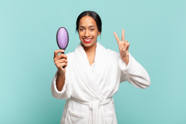 Pretty woman celebrating a triumph and holding brush