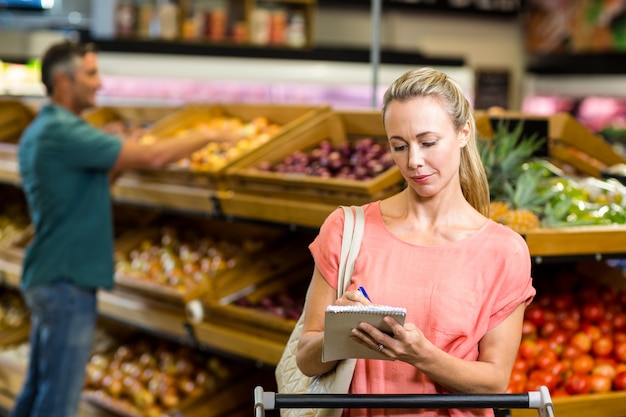 Pretty woman checking grocery list