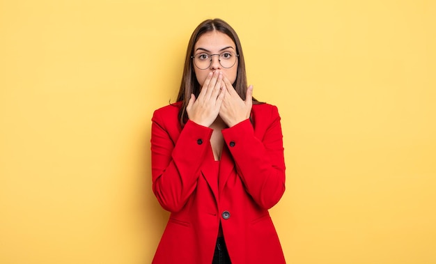 Pretty woman covering mouth with hands with a shocked. businesswoman concept