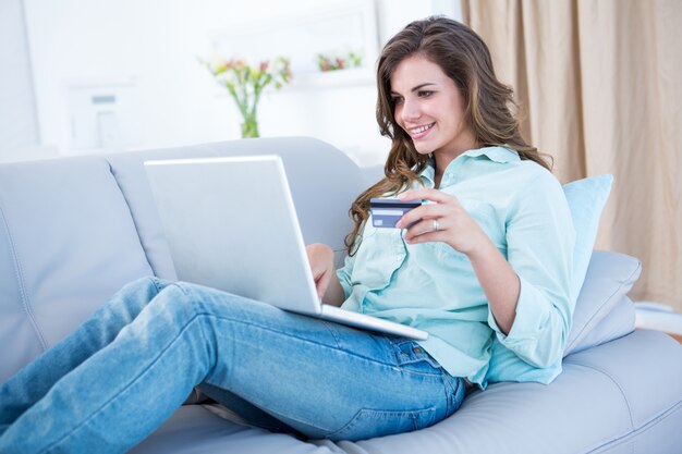 Pretty woman doing online shopping with laptop 