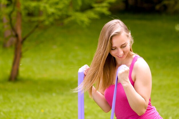 Pretty woman doing yoga exercises in the park portret closeup