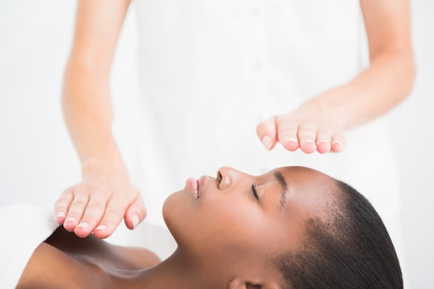 Pretty woman enjoying a reiki technique