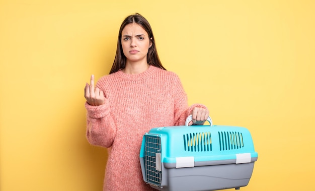 Pretty woman feeling angry, annoyed, rebellious and aggressive. pet carrier concept