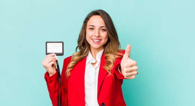 Pretty woman feeling proudsmiling positively with thumbs up