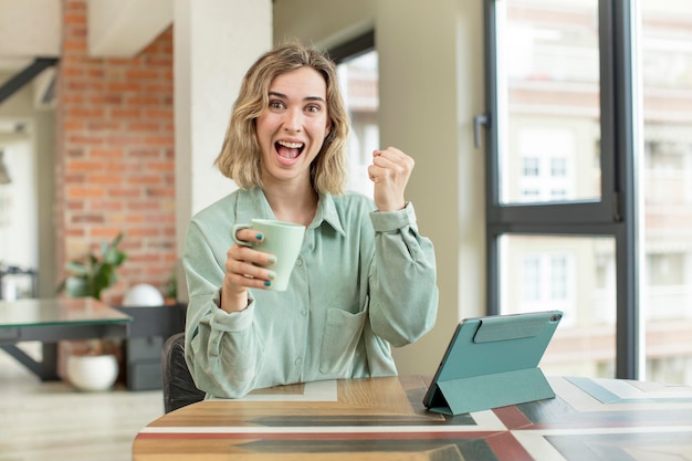 Photo pretty woman feeling shockedlaughing and celebrating success touch screen pad concept