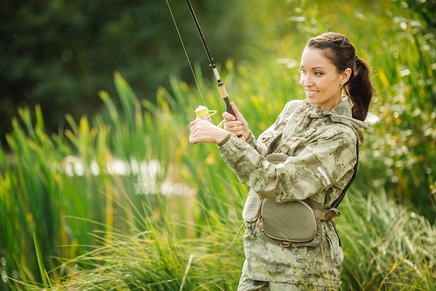 Pretty woman fishes on the river