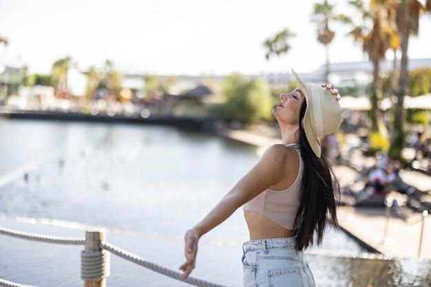 pretty woman in hat breathing by the sea freedom travel tourism concept