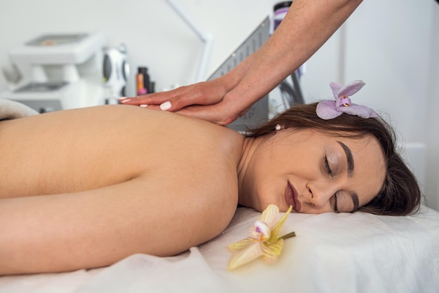 Pretty woman having back massage in spa health lifestyle