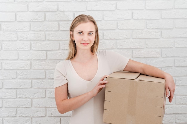 Pretty woman holding cardboard box Delivering a parcel