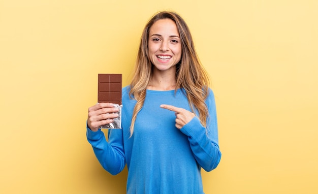 pretty woman holding a chocolate tablet