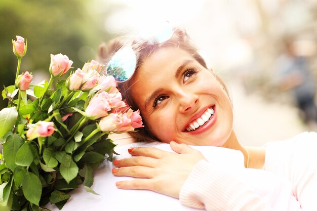 pretty woman holding flowers and hugging a man