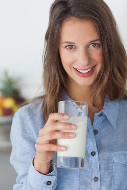 Pretty woman holding a glass of milk