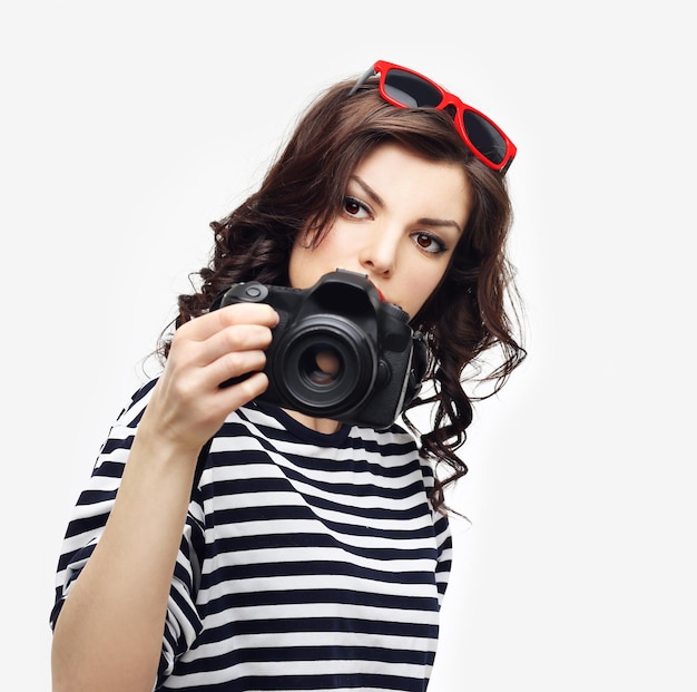 Pretty woman is a professional photographer with dslr camera