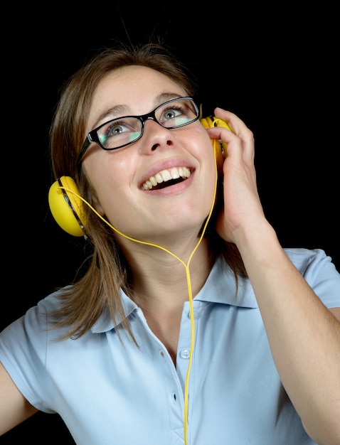 Pretty woman listening to music with a headphone