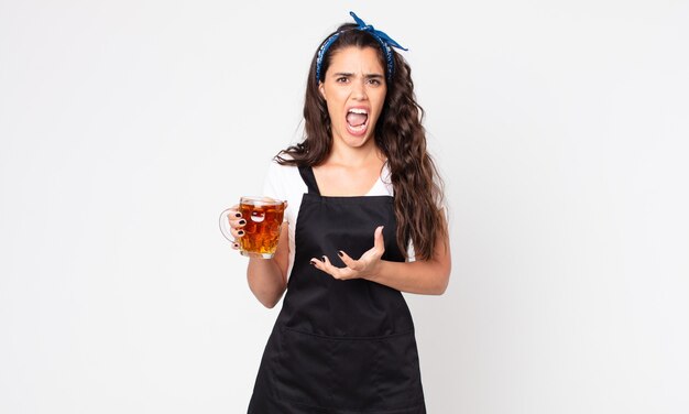 Pretty woman looking angry, annoyed and frustrated and holding a pint of beer