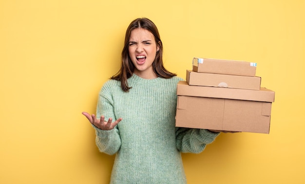 Pretty woman looking angry, annoyed and frustrated packages boxes concept