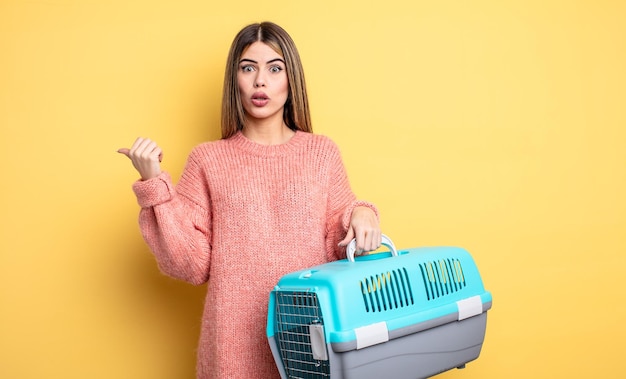 Pretty woman looking astonished in disbelief pet carrier concept