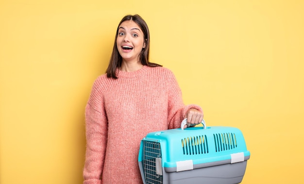 Pretty woman looking happy and pleasantly surprised pet carrier concept