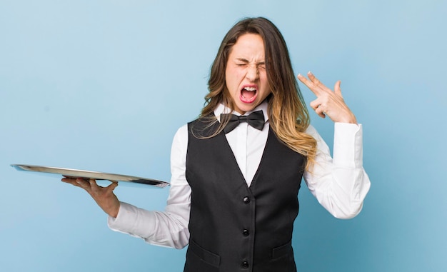 Pretty woman looking unhappy and stressed suicide gesture making gun sign