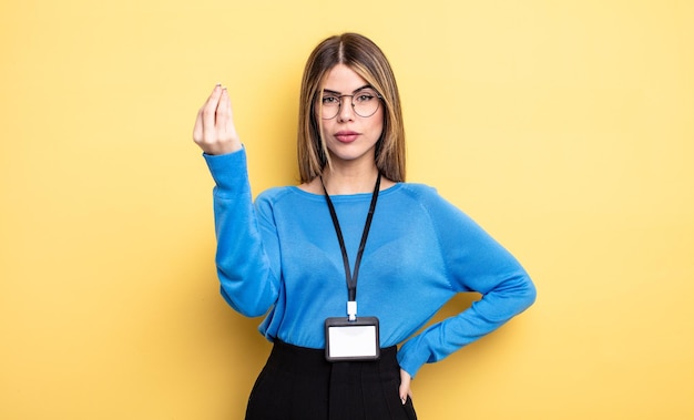 Pretty woman making capice or money gesture telling you to pay accreditation card concept