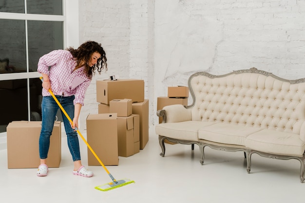 Pretty woman mopping floor