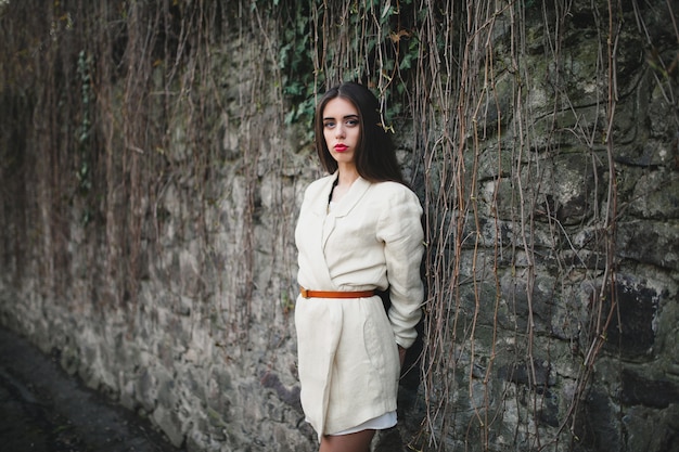 Pretty woman near stone wall