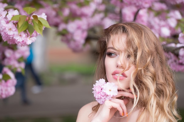 Pretty woman in pink blossom