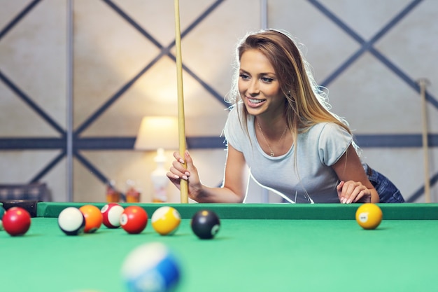 pretty woman playing billards