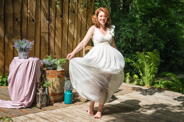 Pretty woman posing in the summer garden