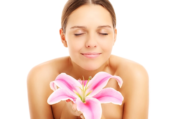 pretty woman posing with flower on white background