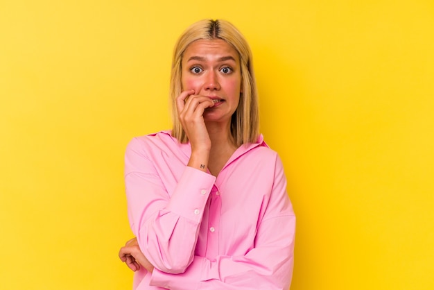 A pretty woman posing over yellow background