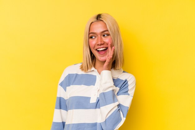 A pretty woman posing over yellow background