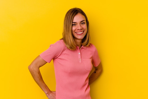 A pretty woman posing over yellow background