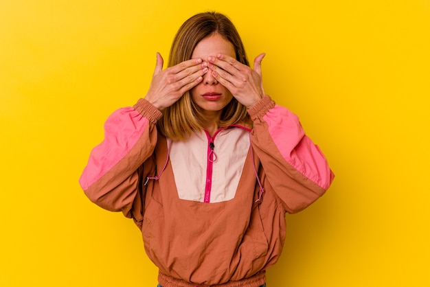 A pretty woman posing over yellow background