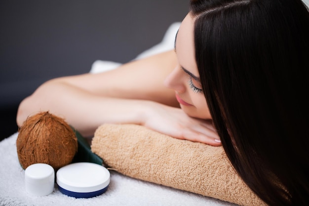 Pretty woman receiving a relaxing massage at the spa salon.