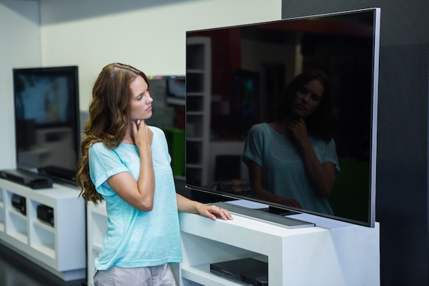 Pretty woman shopping for new television