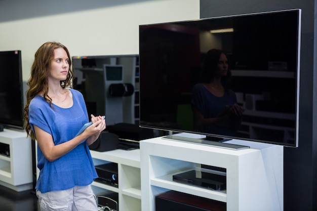 Pretty woman shopping for new television