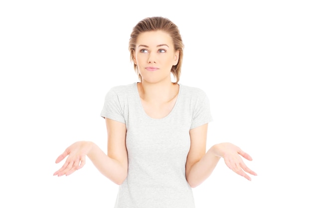 a pretty woman shrugging shoulders over white background