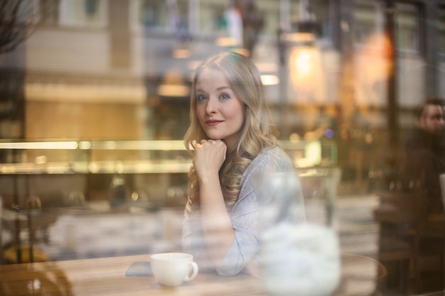 Pretty woman sitting in a bistro