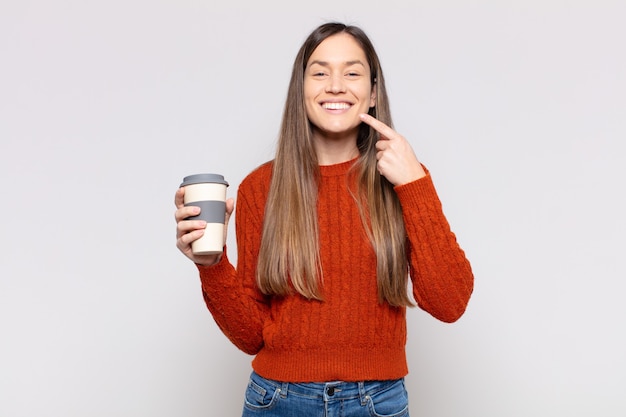 Pretty woman  smiling confidently pointing to own broad smile, positive, relaxed, satisfied attitude