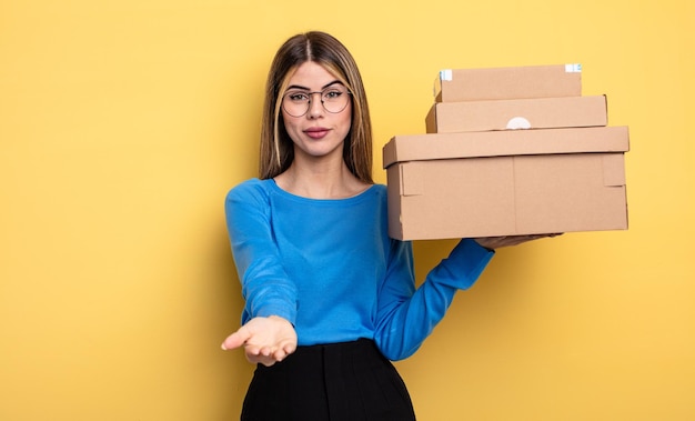 Pretty woman smiling happily with friendly and  offering and showing a concept packages boxes concept