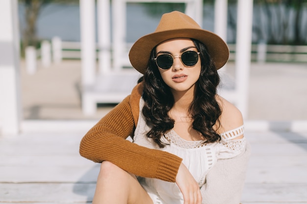 Pretty woman in sunglasses and hat