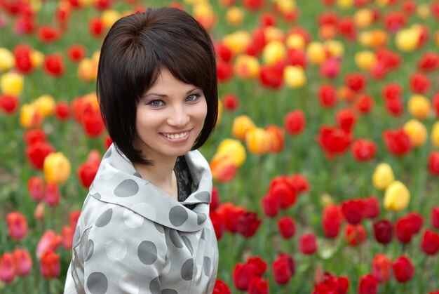 Pretty woman on tulips meadow