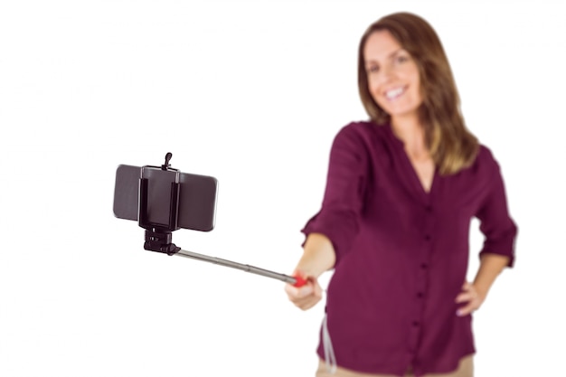 Pretty woman using a selfie stick