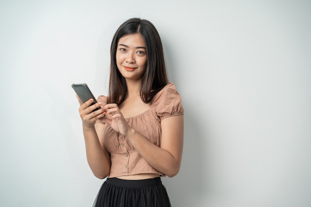 Pretty woman using a smartphone gadget and touch the screen