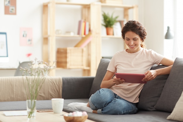 Pretty woman using tablet at home